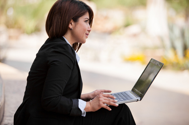 Vista laterale della donna d'affari utilizzando il computer portatile
 - Foto, immagini