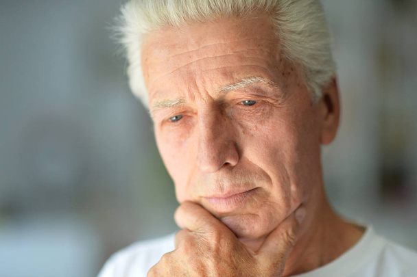 Close up portrait of thoughtful senior man at home - Photo, image