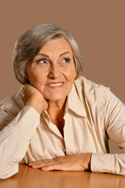 portrait of happy senior woman at table - Zdjęcie, obraz