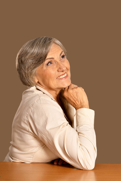 portrait of happy senior woman at table - Photo, Image