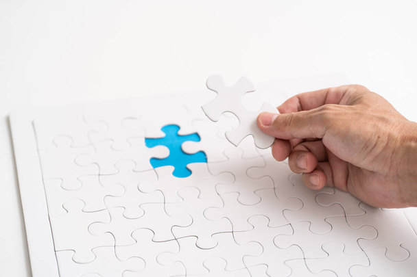 Hand holding jigsaw piece. for business concept - Фото, изображение
