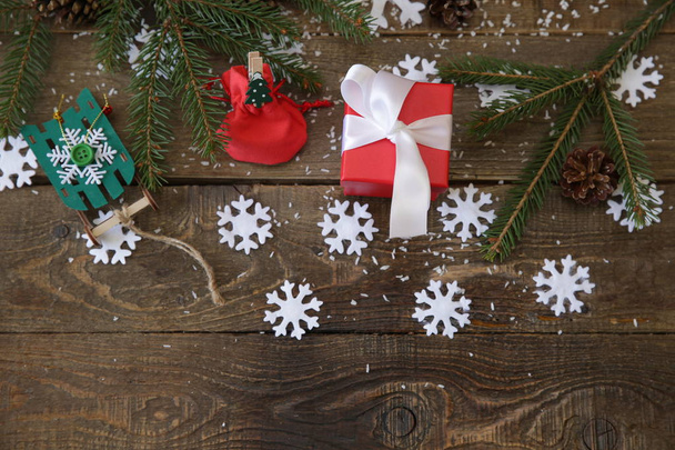 Weihnachtsbaum mit Geschenken und Dekorationen Schneeflocken auf dem hölzernen Hintergrund. Weihnachts- und Neujahrskonzept. flache Lageoberseite mit Kopierraum für Textmuster, Hintergrund, Postkarte. - Foto, Bild