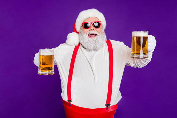 Portrait of nice drunk cheerful cheery glad bearded thick fat Santa having fun offering drinking beer night club bar isolated over bright vivid shine vibrant violet lilac background - Фото, изображение