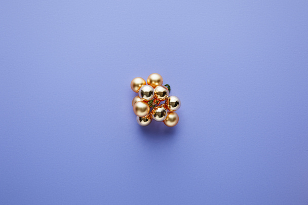 top view of shiny golden Christmas decoration on blue background - Foto, afbeelding