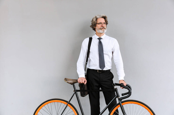 Photo of handsome mature businessman standing with bicycle - Foto, afbeelding