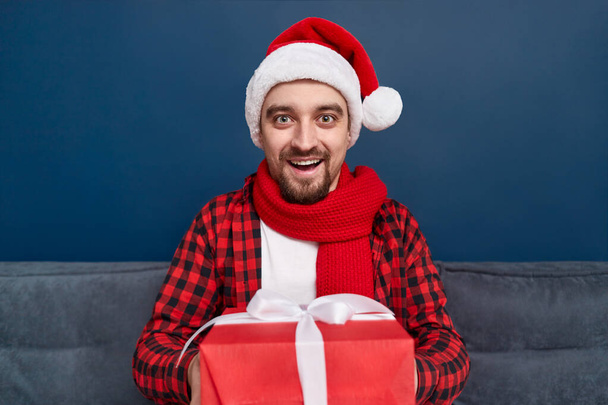 Friendly male giving Christmas presents - Photo, Image