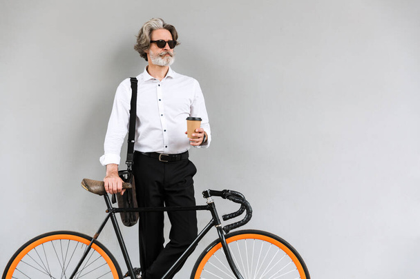 Photo of masculine mature businessman drinking coffee takeaway - Valokuva, kuva