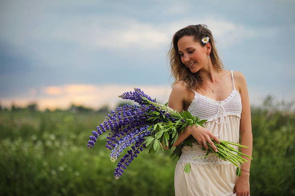 Girl with a bouquet of blue flowers - Fotó, kép