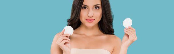 panoramic shot of attractive woman holding cotton pads isolated on blue  - Photo, Image