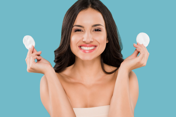 happy woman holding cotton pads isolated on blue  - Photo, Image