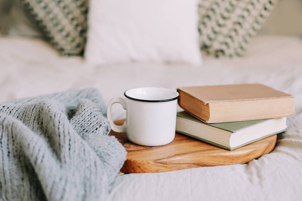 Books and coffee cup. Breakfast in bed.  Good morning. Atmospheric hygge style. flat lay, still life - 写真・画像