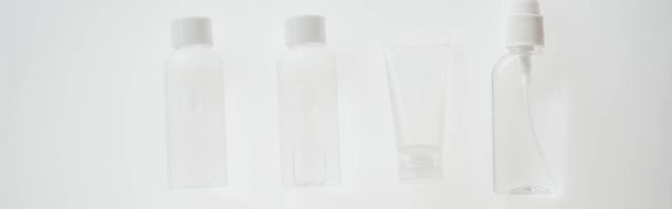 panoramic shot of bottles and tube with liquids on white background  - Fotoğraf, Görsel