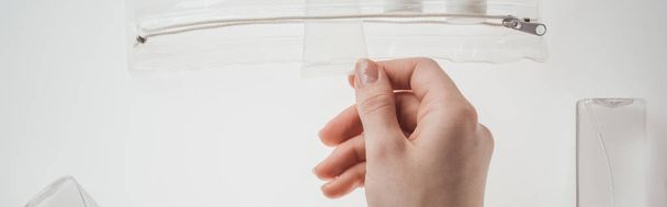 panoramic shot of woman holding tube with liquid on white background  - Fotó, kép