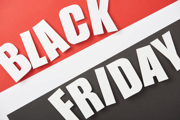 top view of black friday lettering on black, white and red background - Photo, Image