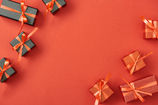 top view of small gift boxes on red background with copy space - 写真・画像