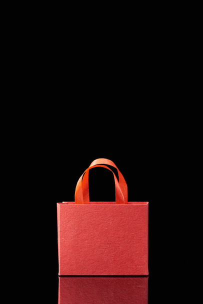 paper red shopping bag with handle isolated on black - Photo, image