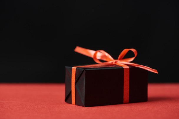 presents with red ribbon and bow isolated on black - Photo, Image