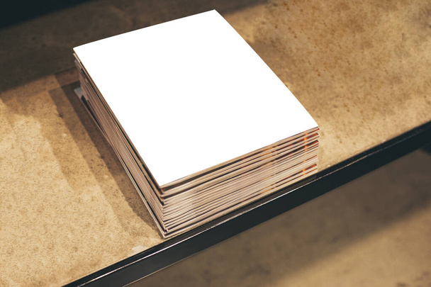 Mock up template of magazine cover. Bunch of glossy magazines on the wooden table. Copy space. - 写真・画像