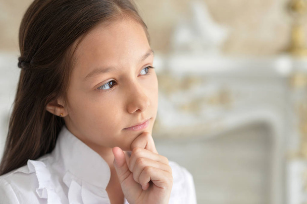 Emotional little girl in white blouse posing at home  - Photo, image