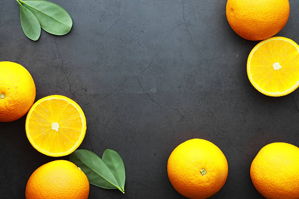 Orange citrus fruit on a stone table. Orange background. - Foto, afbeelding