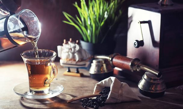 Brewing tea on a wooden table - Фото, зображення