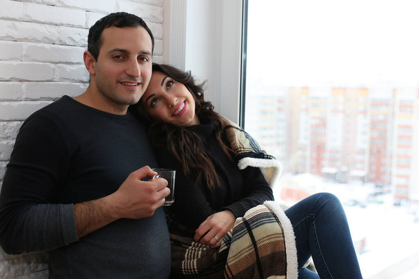 A young married couple in a new apartment - Φωτογραφία, εικόνα