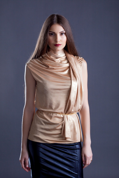 Sensual woman advertises stylish clothes in studio - Фото, изображение