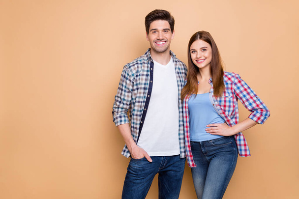 Portrait of his he her she nice attractive charming lovely romantic cheerful cheery couple wearing checked shirt embracing spending holiday isolated over beige pastel color background - Foto, imagen