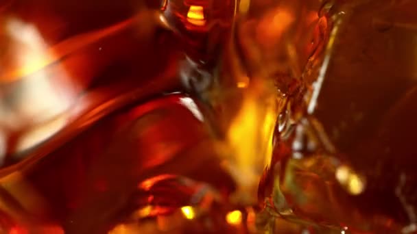 Super slow motion of pouring whiskey into glass, super macro shot. Filmed on high speed cinema camera, 1000fps - Felvétel, videó
