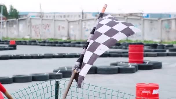 Close-up view of red and checkered start and finish flags on the outdoor karting track. Media. Kart racing - Footage, Video