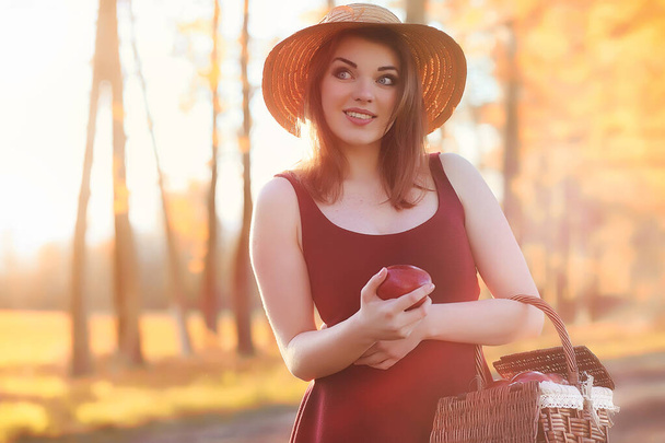 A girl in a hat on a walk in the park. A girl with a basket walk - Photo, Image