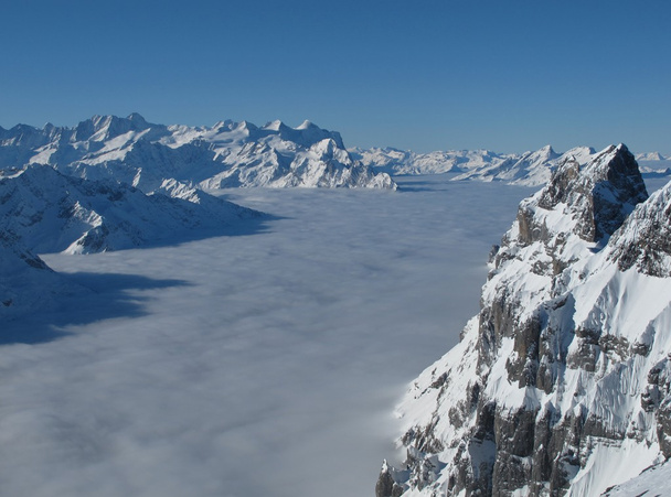 View from the Titlis, famous mountain in the Swiss Alps - Photo, Image