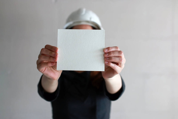 woman with a blank sheet of paper in his hand on construction si - Foto, afbeelding