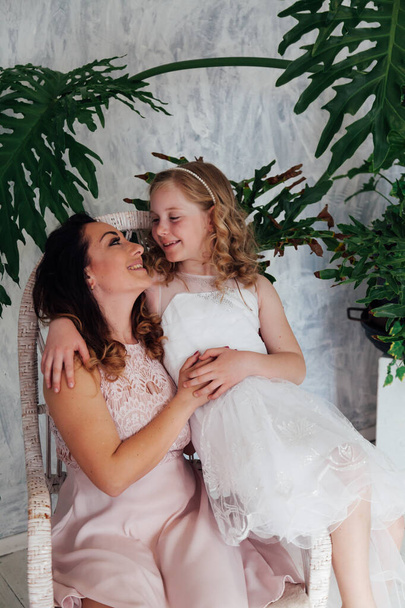 Mom and daughter in white dresses hold hands - Valokuva, kuva