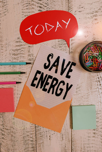 Word writing text Save Energy. Business concept for decreasing the amount of power used achieving a similar outcome Envelop speech bubble paper sheet ballpoints notepads clips wooden back. - Photo, Image
