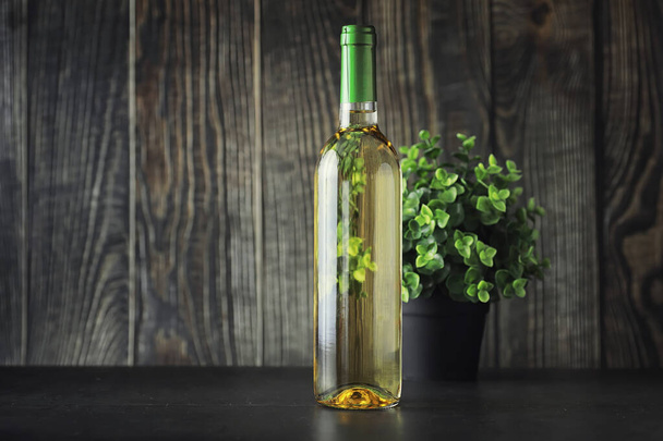 Transparent bottle of white dry wine on the table. White wine gl - Fotoğraf, Görsel