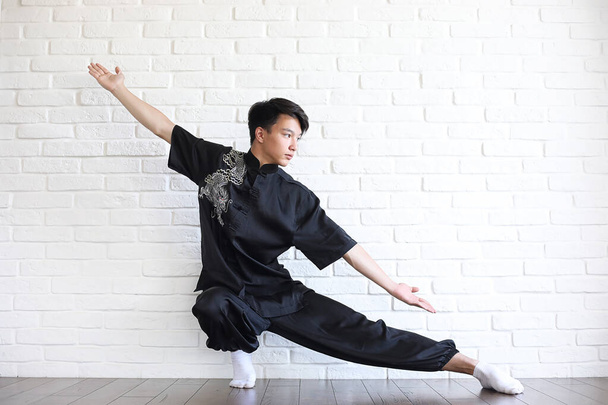 Asian young novice on a white brick wall - 写真・画像