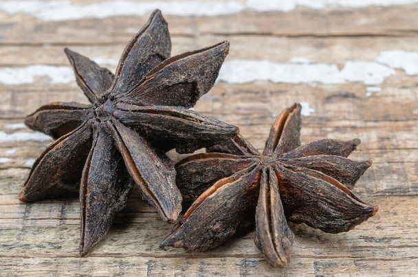 Two star anise star anise on wooden background. - Photo, Image