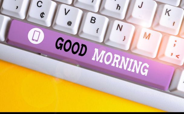 Conceptual hand writing showing Good Morning. Business photo showcasing A conventional expression at meeting or parting in the morning White pc keyboard with note paper above the white background. - Photo, Image