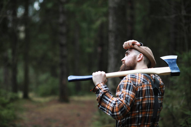 A bearded lumberjack with a large ax  - Photo, Image