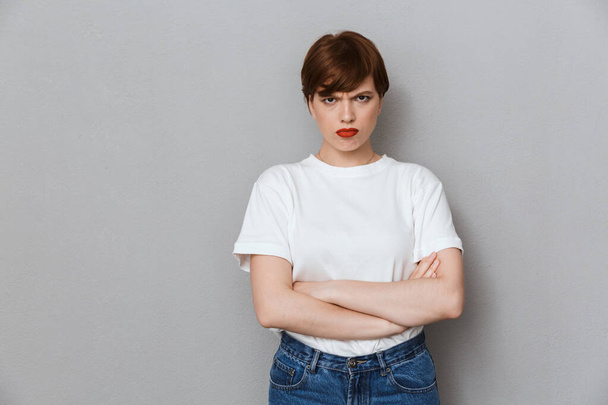 Image of angry brunette woman frowning and standing with arms cr - Foto, Imagem