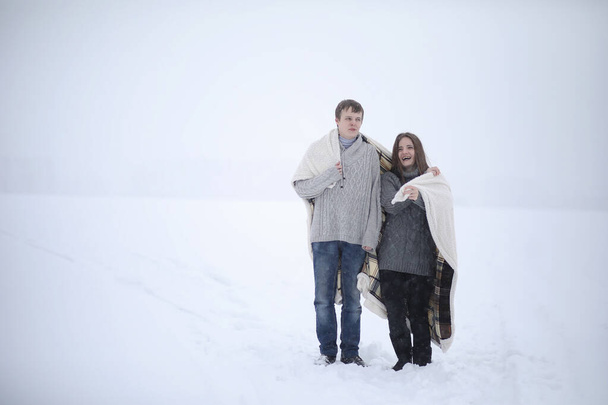 pair of lovers on a date winter afternoon in a snow blizzard - Foto, imagen