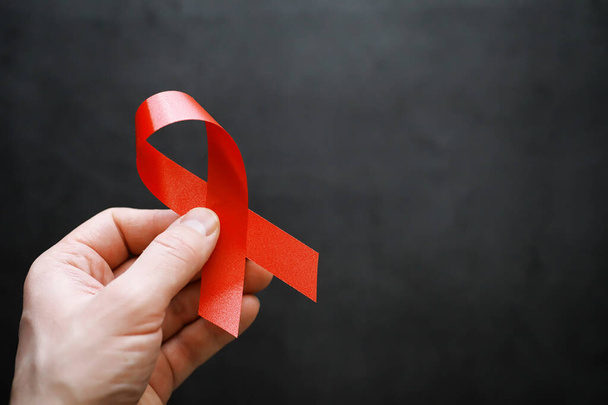 Symbol of human immunodeficiency virus disease. Red ribbon. A he - Photo, Image