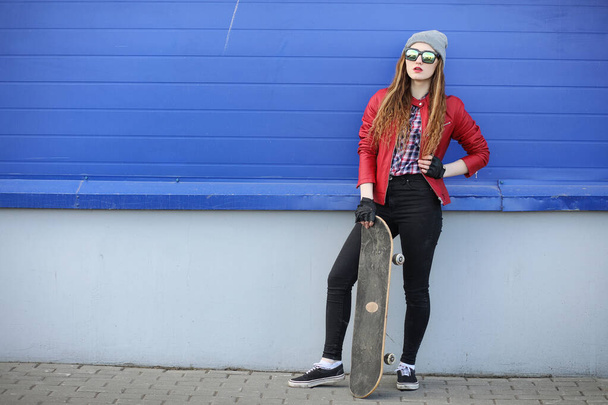 A young hipster girl is riding a skateboard. Girls girlfriends f - Valokuva, kuva