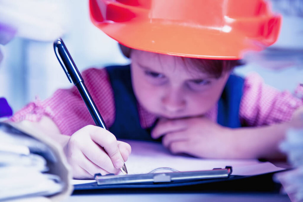 Cute little business child girl architect in construction helmet - Photo, Image