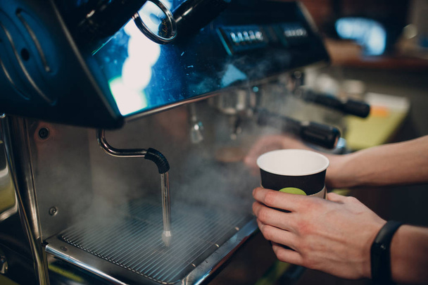 Barista makes coffee in a coffee machine - Foto, Imagen