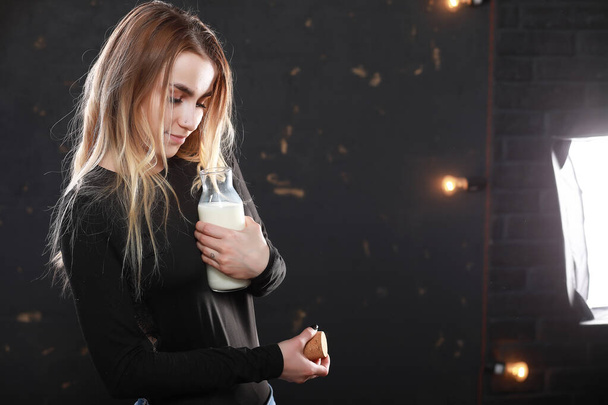 Young girl drinks milk from a bottle - Φωτογραφία, εικόνα