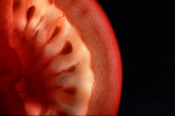 Red tomato cut in half with the texture of seeds - Fotó, kép