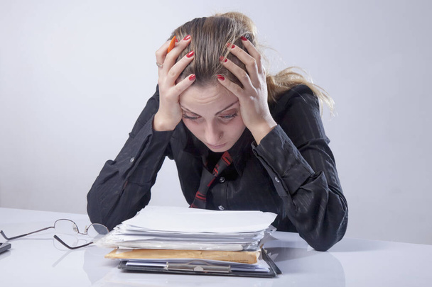 Portrait of depressed business woman working in office as symbol - Foto, afbeelding