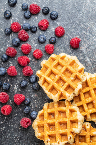 Waffles with blueberries and raspberries. - Foto, Imagen